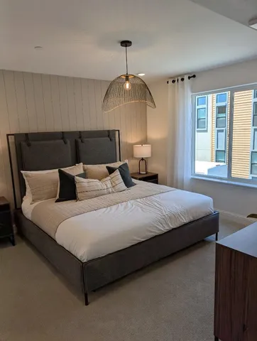 a bedroom with bed and window