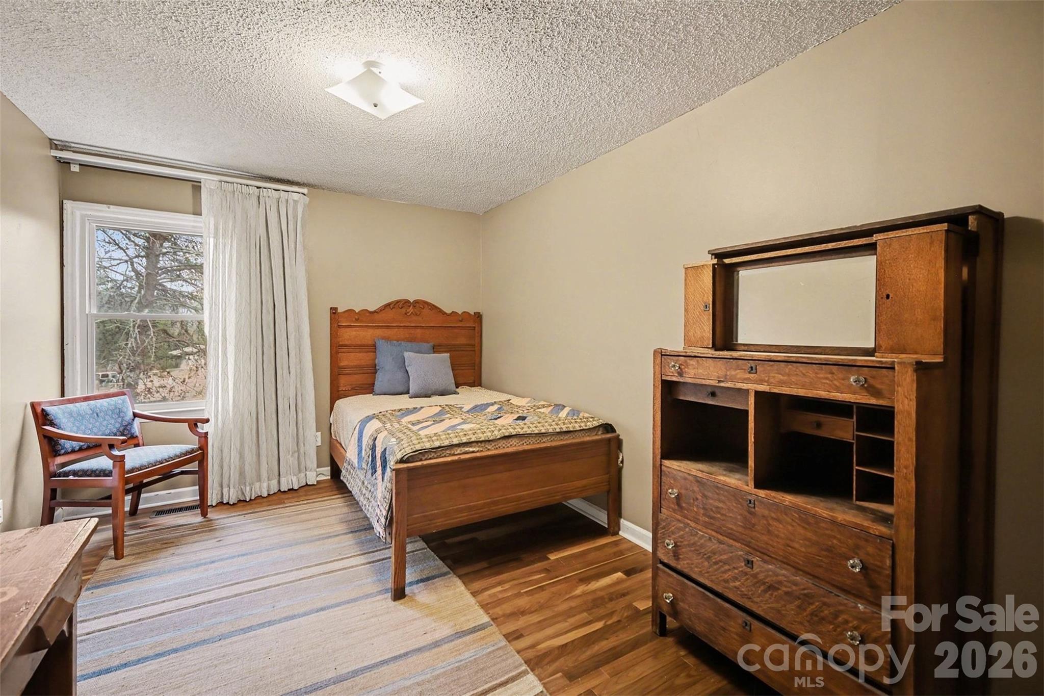 16421 Shallow Pond Road Charlotte, NC 28278 - Photo 13 of 24 a bedroom with a bed and wooden floor