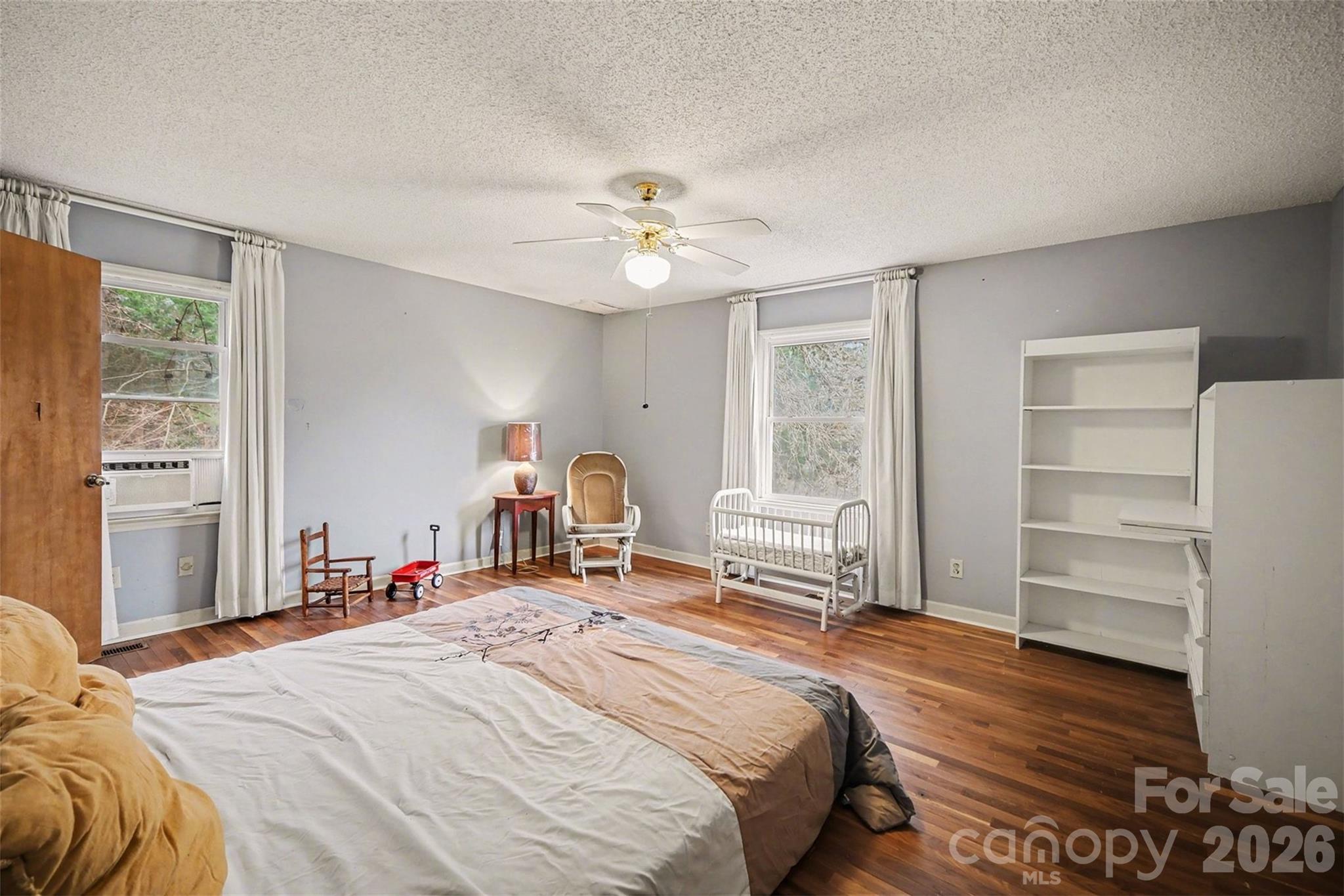 16421 Shallow Pond Road Charlotte, NC 28278 - Photo 14 of 24 a bedroom with a bed and a chandelier