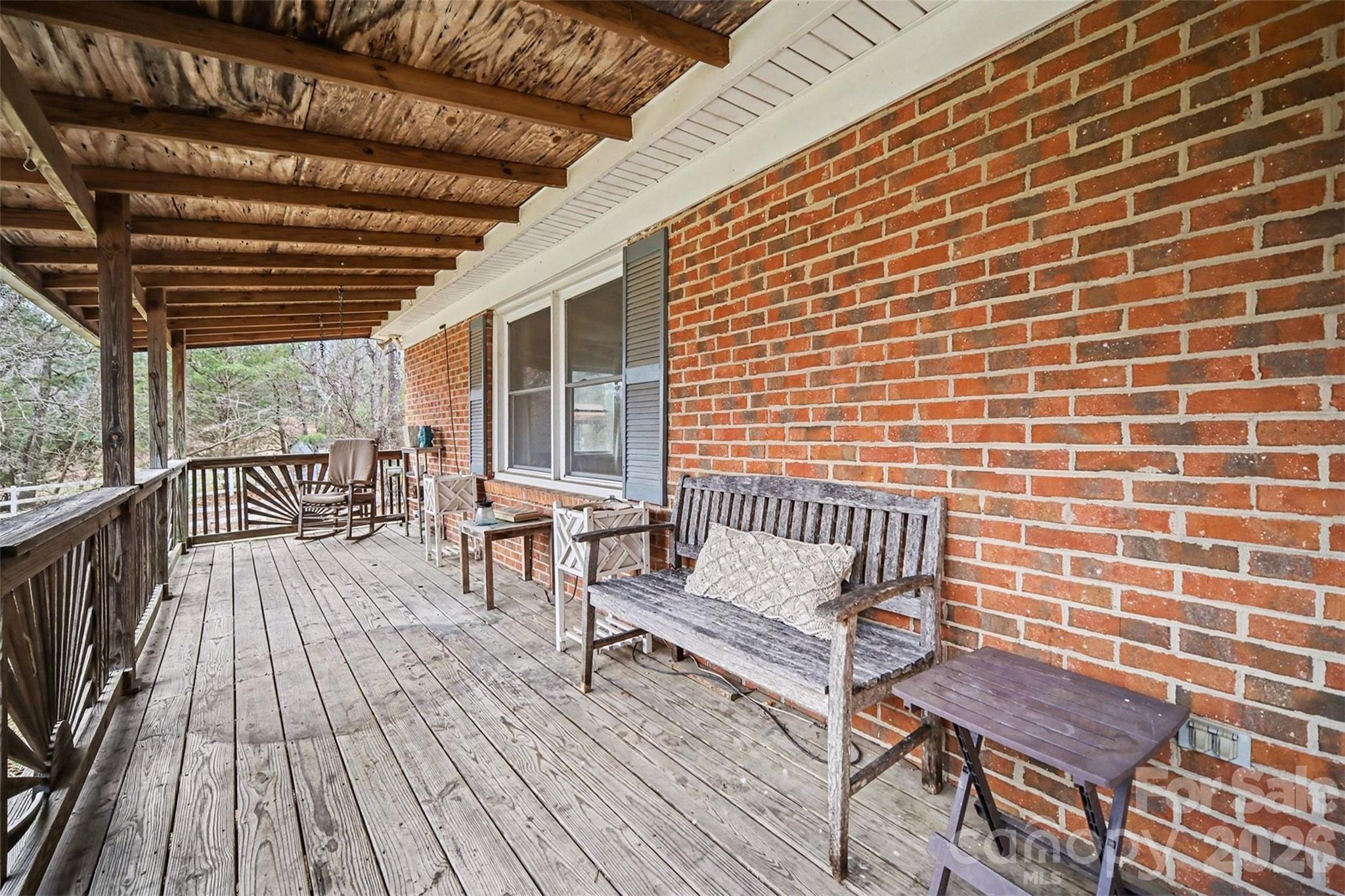 16421 Shallow Pond Road Charlotte, NC 28278 - Photo 3 of 24 a balcony with wooden benches and a barbeque