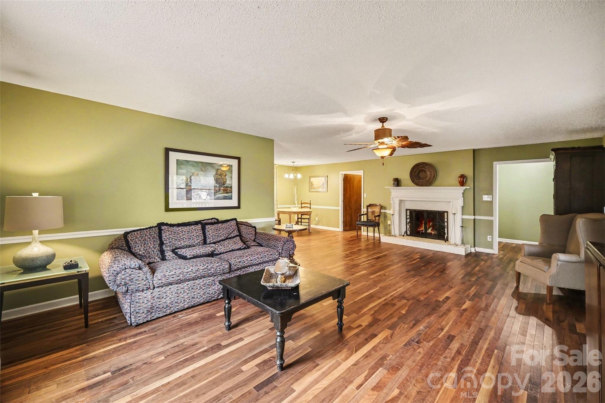 16421 Shallow Pond Road Charlotte, NC 28278 - Photo 6 of 24 a living room with furniture a fireplace and a flat screen tv
