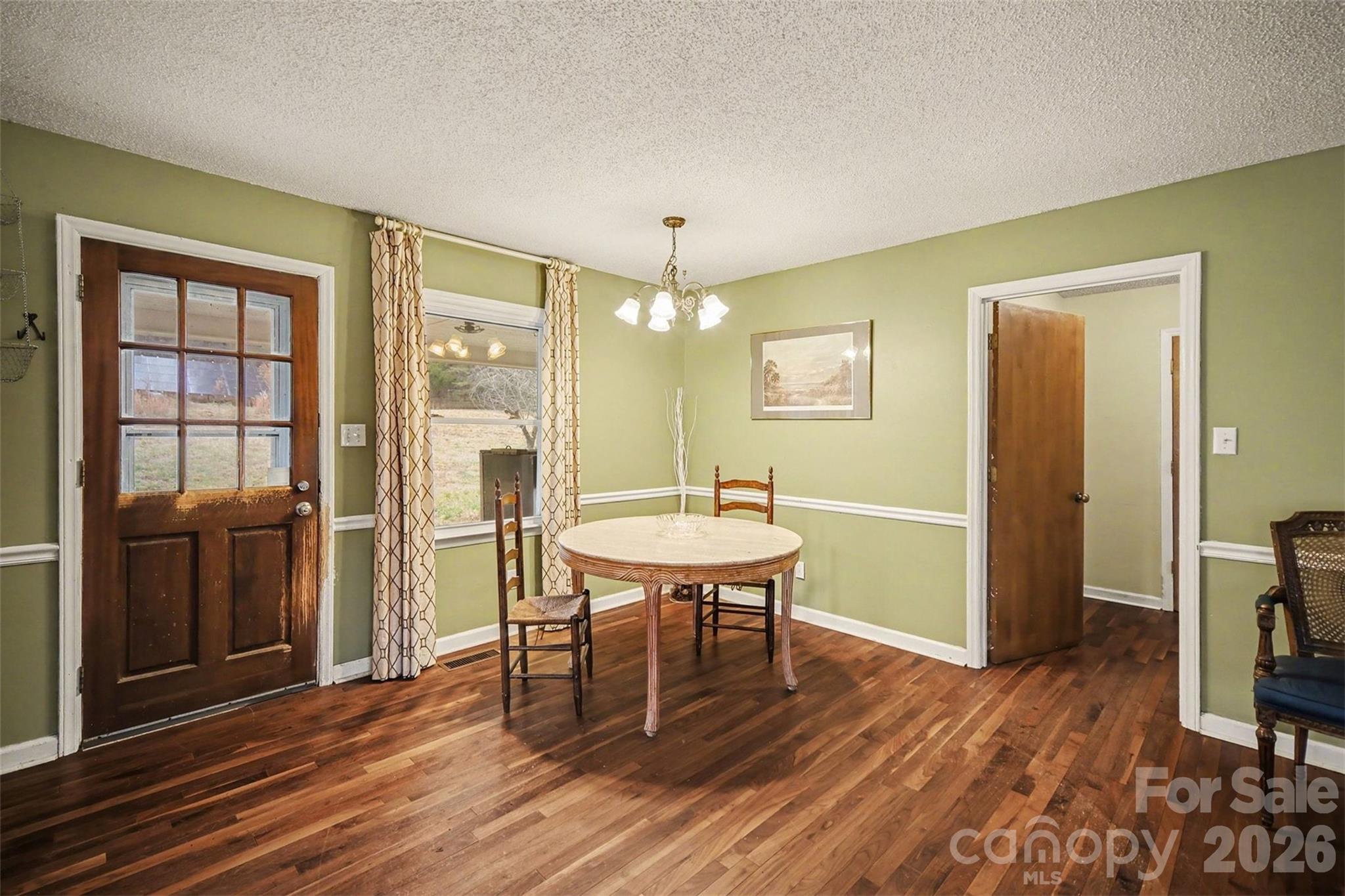 16421 Shallow Pond Road Charlotte, NC 28278 - Photo 9 of 24 a view of a dining room with furniture and wooden floor