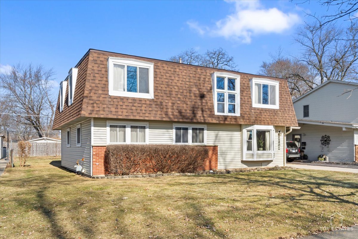 2302 Fulle Street Rolling Meadows, IL 60008 - Photo 13 of 48 a front view of a house with a yard