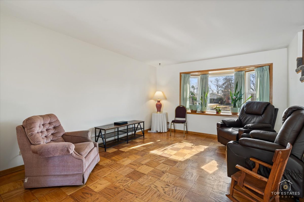 2302 Fulle Street Rolling Meadows, IL 60008 - Photo 2 of 48 a living room with furniture a large window and a rug