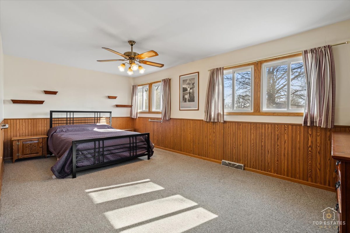 2302 Fulle Street Rolling Meadows, IL 60008 - Photo 22 of 48 a bedroom with a bed and a chandelier