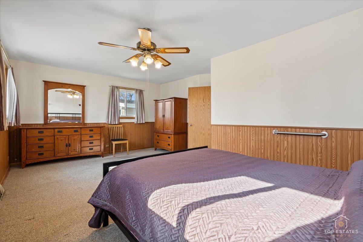 2302 Fulle Street Rolling Meadows, IL 60008 - Photo 5 of 48 a bed room with a bed and a chandelier