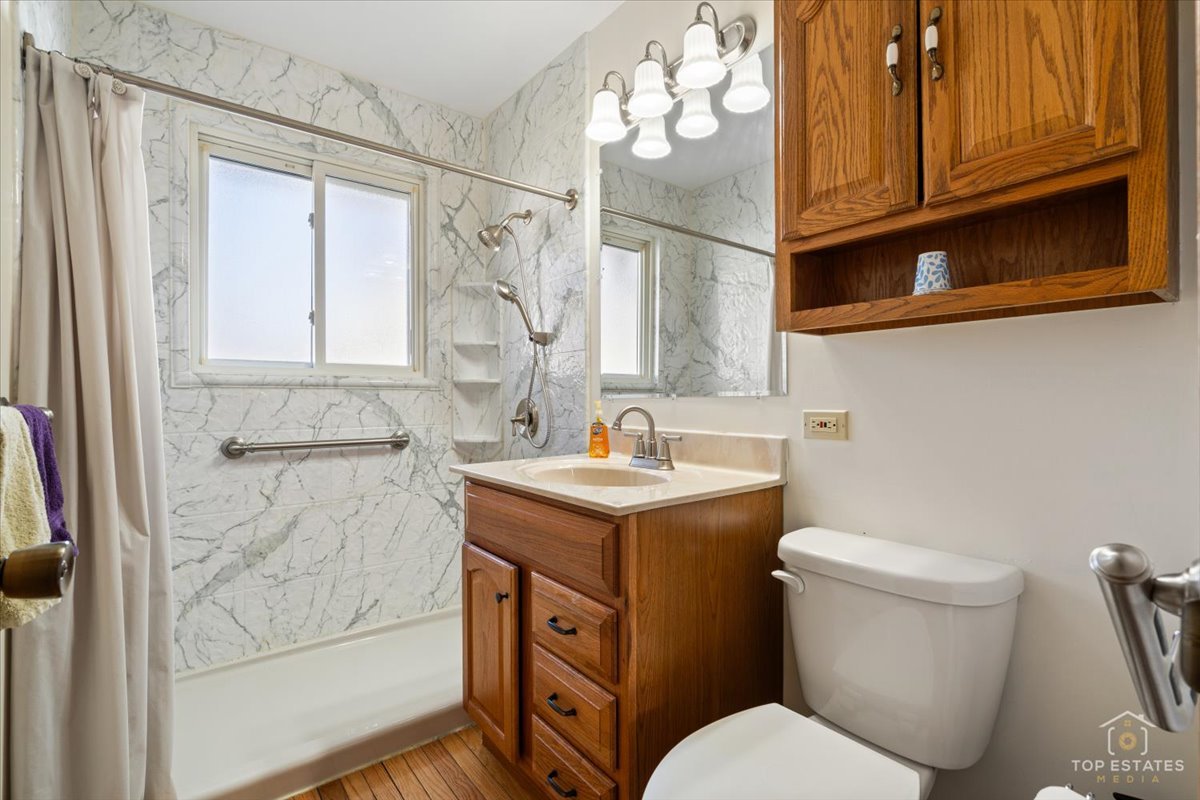 2302 Fulle Street Rolling Meadows, IL 60008 - Photo 6 of 48 a bathroom with a granite countertop toilet sink and mirror