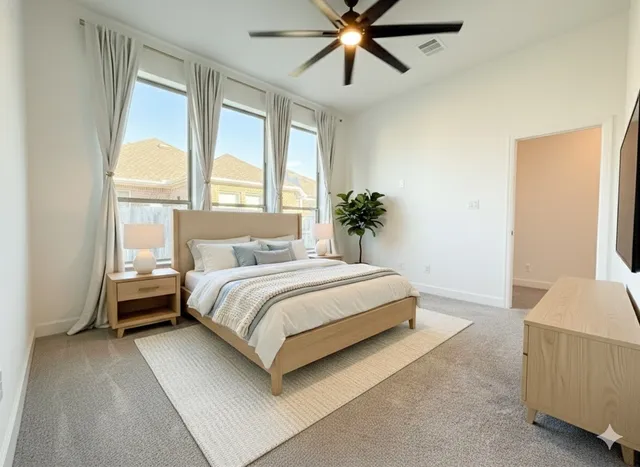 a bedroom with a large bed and a chandelier