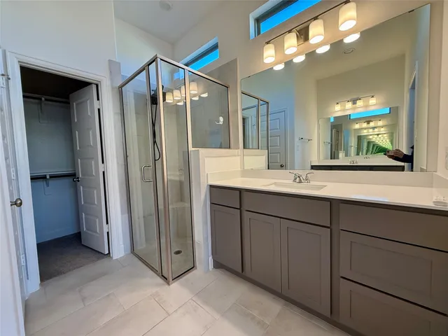 a bathroom with a double vanity sink and a mirror