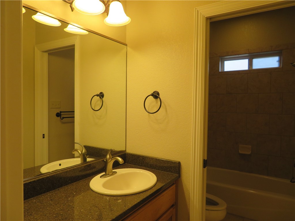 5803 South Oso Parkway Corpus Christi, TX 78414 - Photo 30 of 39 a bathroom with a sink a toilet and shower