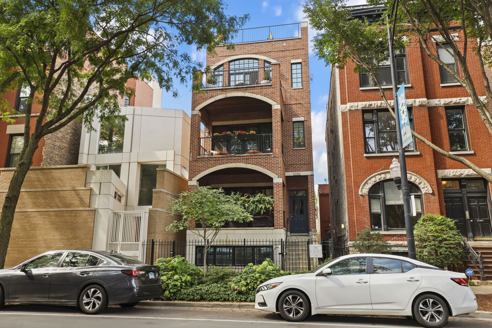 a front view of a residential apartment building with a yard