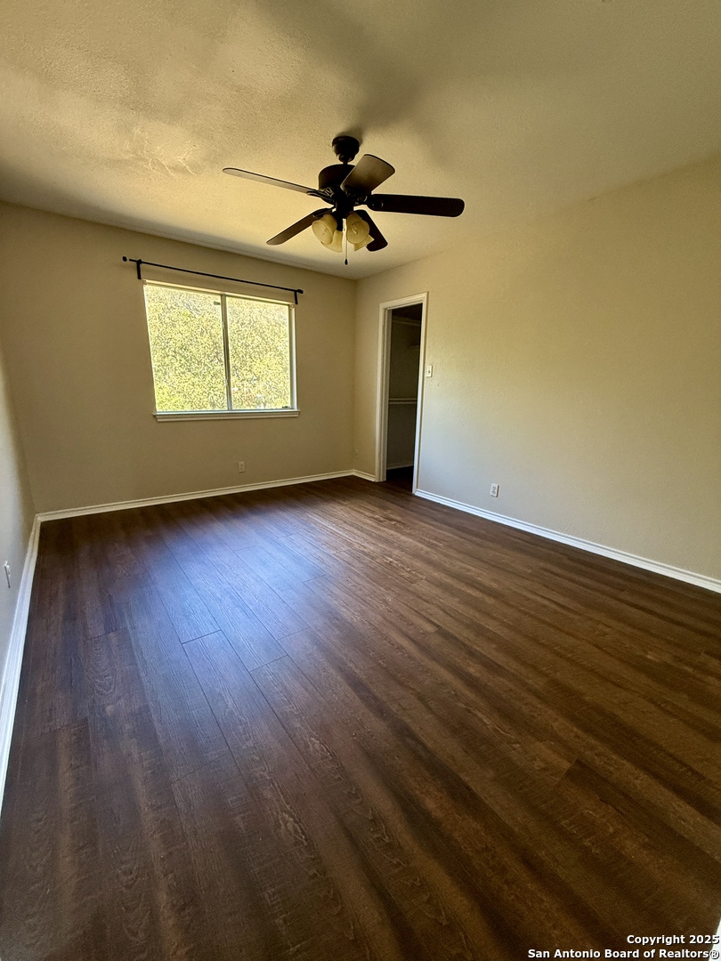 821 Dimrock Schertz, TX 78154 - Photo 15 of 20 a view of an empty room with wooden floor and a window