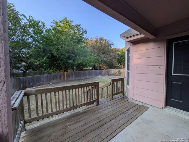 a balcony with wooden floor and fence