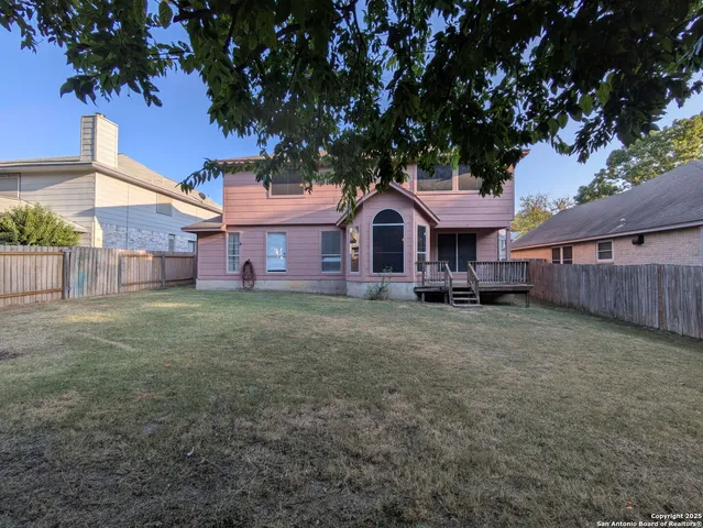 a front view of a house with a garden and tree