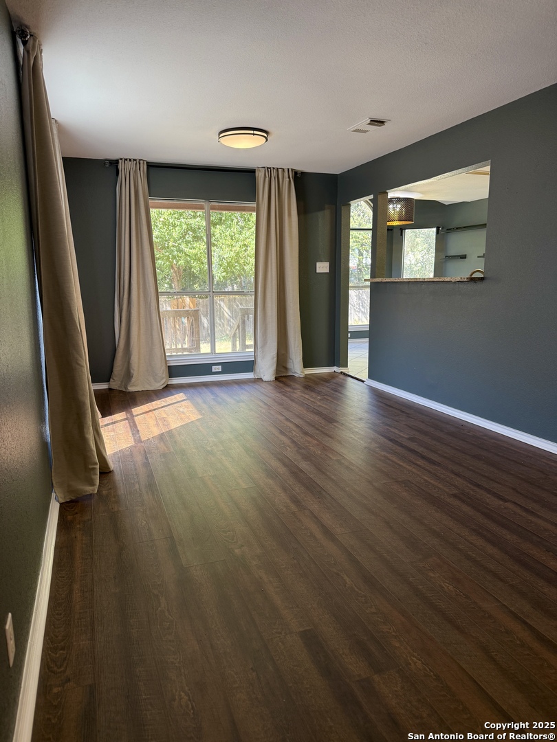 821 Dimrock Schertz, TX 78154 - Photo 4 of 20 an empty room with wooden floor and windows