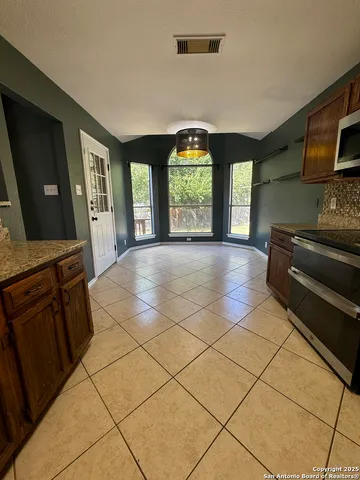 a view of a kitchen with furniture and window