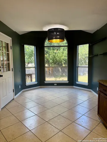 a view of room with windows and chandelier