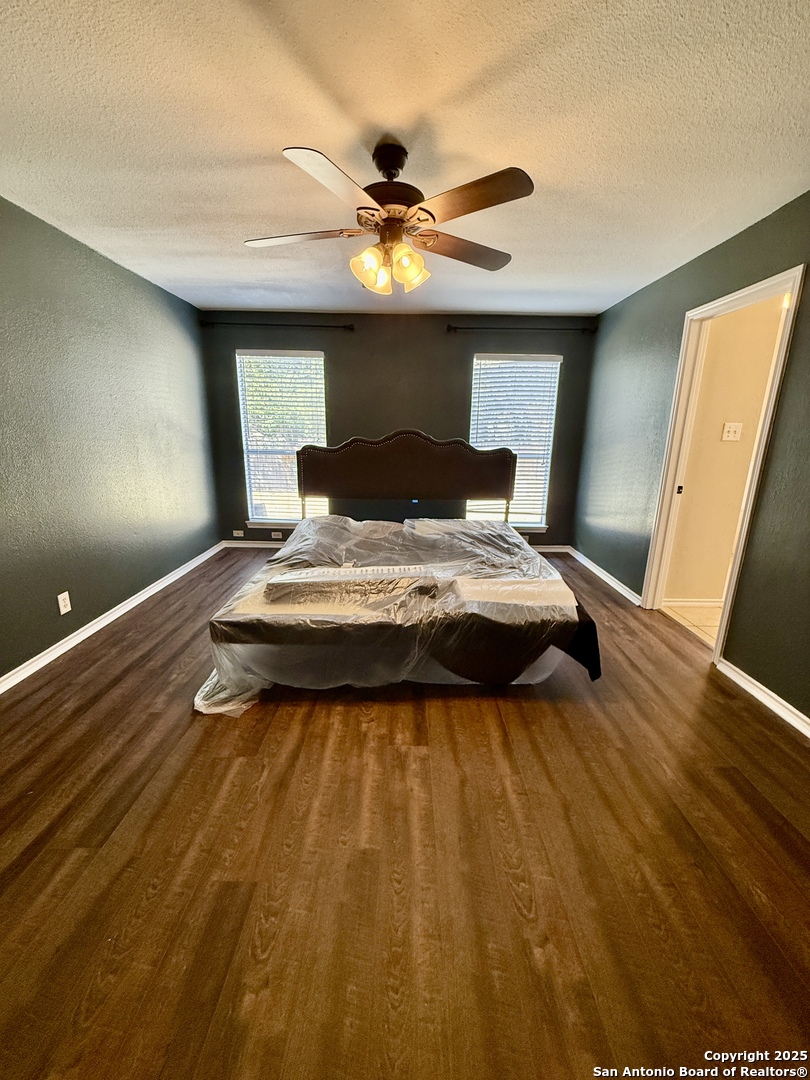 821 Dimrock Schertz, TX 78154 - Photo 7 of 20 a bedroom with a bed and a chandelier