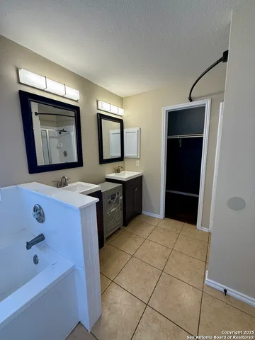 a kitchen with stainless steel appliances a sink and a refrigerator