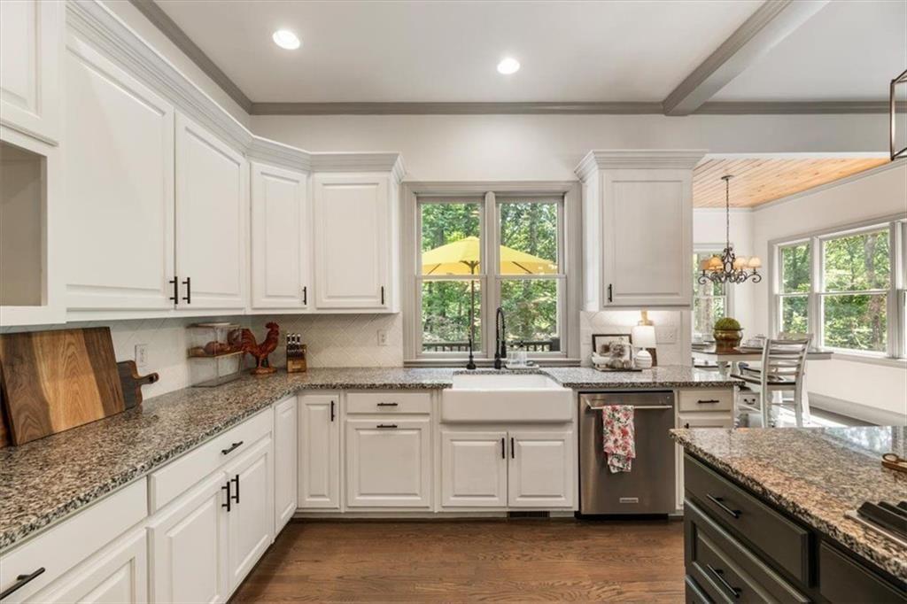 3910 Two Rivers Drive Cumming, GA 30041 - Photo 31 of 110 a kitchen with granite countertop white cabinets stainless steel appliances a sink and a large window