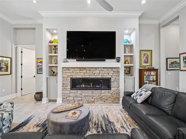 a dining room with furniture a chandelier and wooden floor