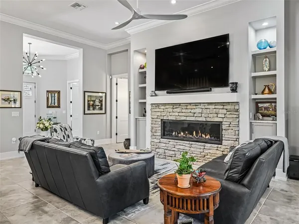 a living room with fireplace furniture and a flat screen tv