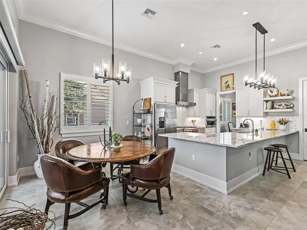 a kitchen with stainless steel appliances kitchen island granite countertop a stove and a sink