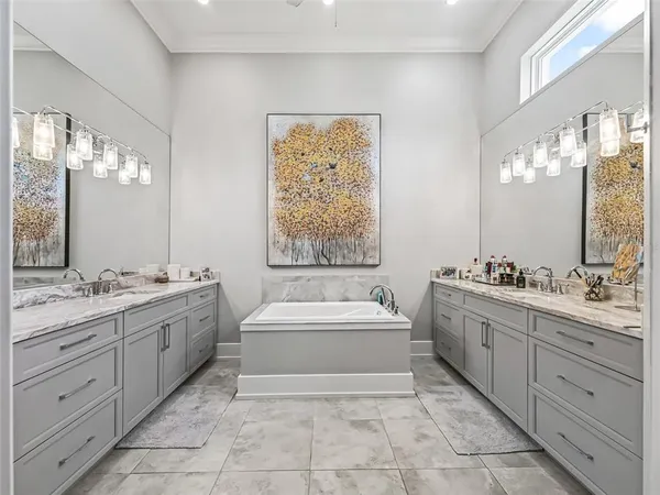 a bathroom with a double vanity sink toilet and shower
