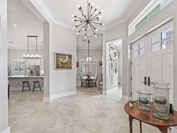 a view of a dining room with furniture wooden floor and a chandelier