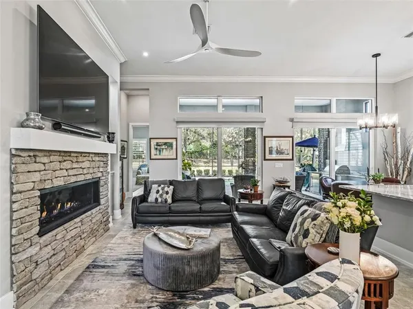 a living room with lots of furniture and kitchen view