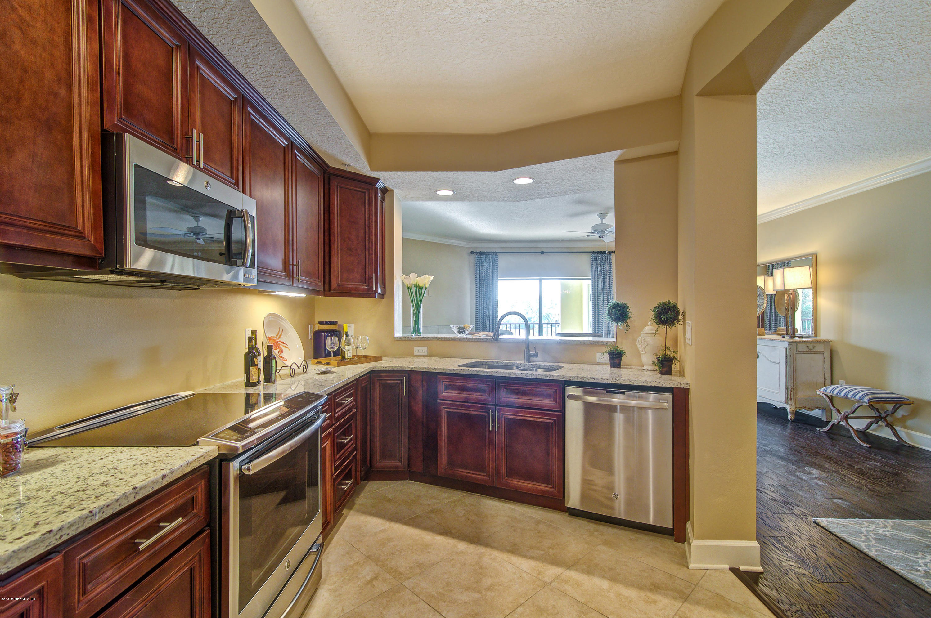 3958 Baymeadows Road, Unit 2602 Jacksonville, FL 32217 - Photo 6 of 14 a kitchen with stainless steel appliances granite countertop a sink stove and cabinets