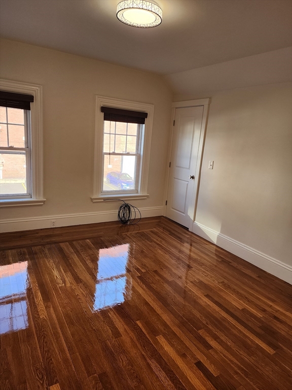 a room with wooden floor and window
