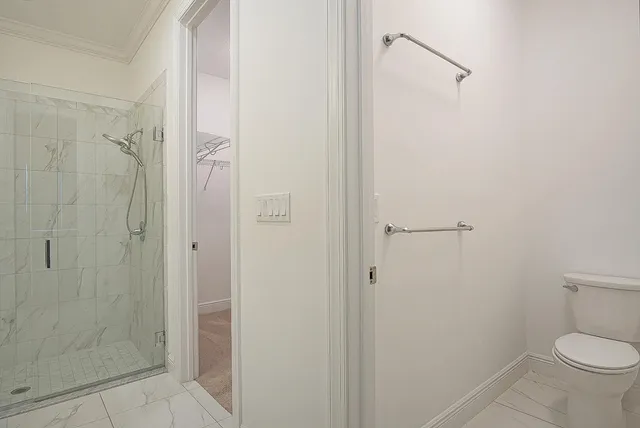 a bathroom with a granite countertop shower and a toilet