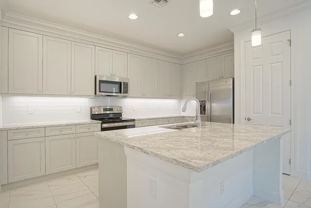 a kitchen with sink cabinets and microwave