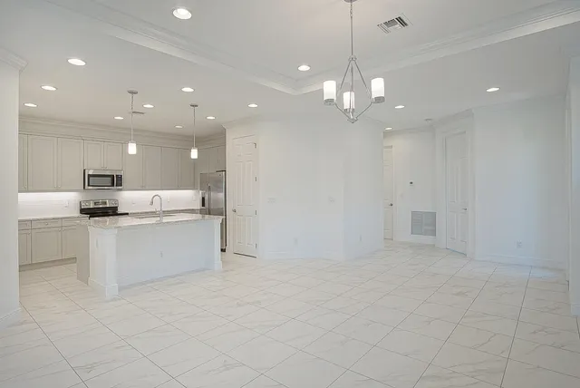 a view of kitchen with granite countertop cabinets a counter top space appliances and a ceiling