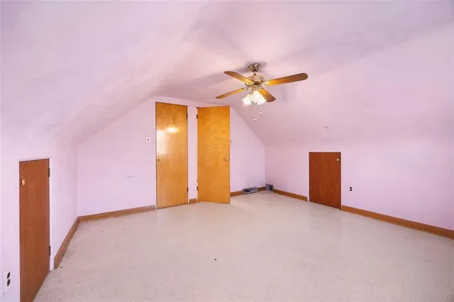 an empty room with a empty space and a ceiling fan