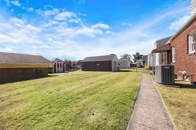 a swimming pool with yard in front of it