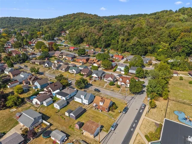 an aerial view of residential houses with outdoor space