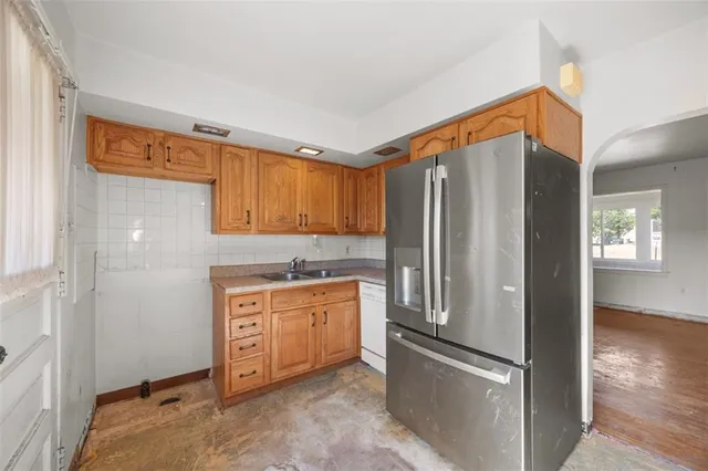 a kitchen with stainless steel appliances granite countertop a refrigerator and a stove