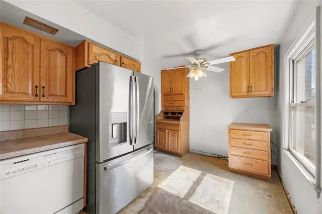 a kitchen with stainless steel appliances granite countertop a refrigerator and a stove top oven