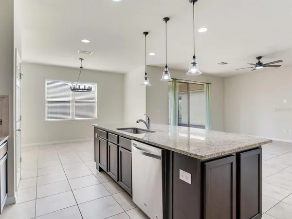 a kitchen with stainless steel appliances granite countertop a sink a oven a counter space and cabinets