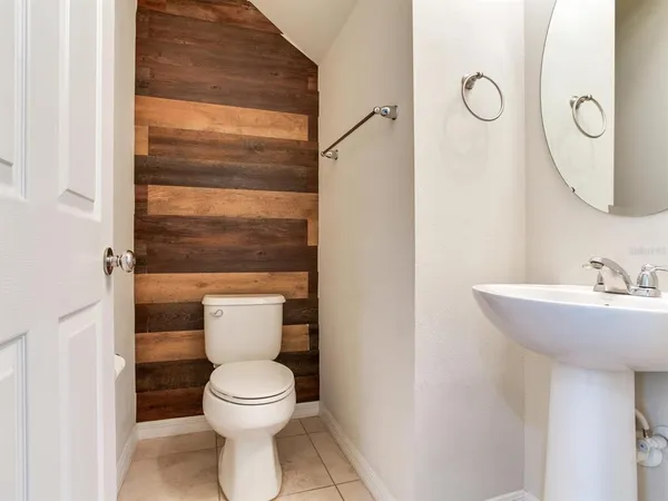 a bathroom with a toilet a sink and a mirror