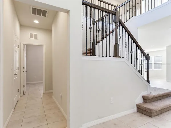 a view of staircase with railing and white walls