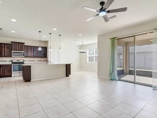 a large kitchen with stainless steel appliances kitchen island granite countertop a sink and cabinets