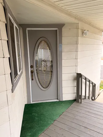 a view of a livingroom with wooden floor and entryway