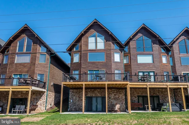 a house view with a garden and large trees
