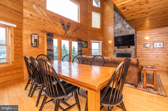 a dining room with furniture and a flat screen tv
