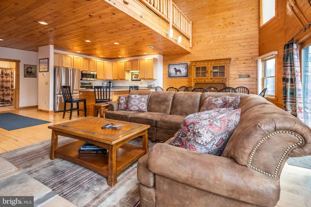 a living room with fireplace furniture and a flat screen tv