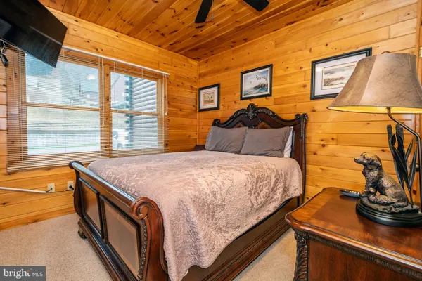 a bedroom with a bed and dresser with mirror