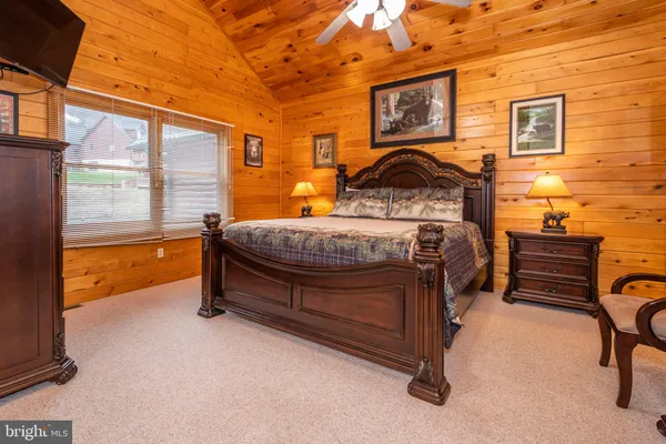 a bedroom with a bed dresser and a window